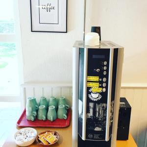 a counter top with a coffee machine and some dishes at Karlshamn vandrarhem och hotell AB in Karlshamn