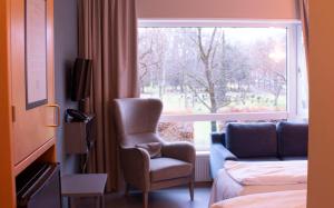 a hotel room with a chair and a window at Ullevål Hotel in Oslo