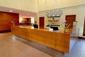 a lobby with a reception desk with clocks on the wall at Apto Residencial Vista Azul - Pedra Azul - ES in Domingos Martins +47 photos
