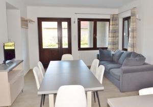 a living room with a table and a couch at Guest House Magyarlukafa in Magyarlukafa