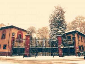 a fence in front of a house with snow on it at B&B San Martino in Mede