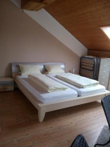 a bedroom with a large bed in a room at Gaestehaus Kasper in Kenzingen