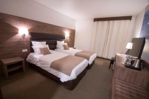 Katil atau katil-katil dalam bilik di Hôtel Bastide