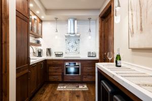 a kitchen with wooden cabinets and a stove top oven at Silver Strike Lodge #201 - 2 Bed in Park City