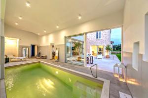 an indoor swimming pool in a house at Villa Vela Muline - 8 plus 2 guests - heated pool in Ugljan