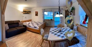 a living room with a couch and a table at Ferienwohnung Ruhepol in Lechbruck