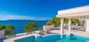 a swimming pool on a balcony with a view of the ocean at Luxury Rooms Villa Jadranka in Makarska