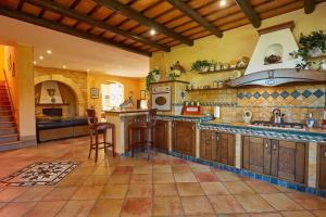 a large kitchen with wooden cabinets and a stove at Scent Selinunte Garden in Castelvetrano Selinunte