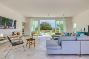 a living room with a gray couch and chairs at Villa Vela Muline - 8 plus 2 guests - heated pool in Ugljan