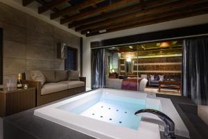 a large bath tub in a room with a couch at HOTEL ZEN Yokohama Hazawa in Yokohama