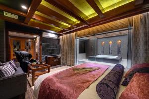 a bedroom with a large bed and a bath tub at HOTEL ZEN Yokohama Hazawa in Yokohama +14 photos