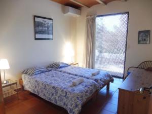 a bedroom with a bed and a large window at Belvilla by OYO Casa Lourdes in Sant Miquel de Balansat