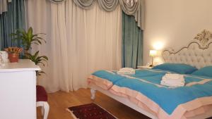 1 dormitorio con 1 cama con toallas en E&E Apartments 4* Arena Stožice en Liubliana