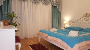 a bedroom with a bed with towels on it at E&E Apartments 4* Arena Stožice in Ljubljana