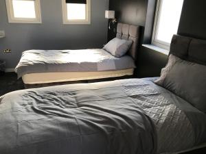 Postel nebo postele na pokoji v ubytování Cozy Rooms