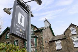 a street sign in front of a brick building at Puddle Duck Lodge – Adults Only in Bowness-on-Windermere