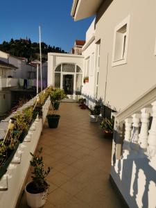 a balcony of a house with potted plants at Guest accommodation house Greta in Tribunj +35 photos