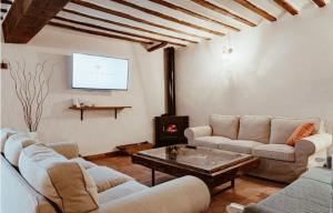 a living room with couches and a fire place at Casa Rural Villa Margarita in Dosbarrios