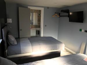 Postel nebo postele na pokoji v ubytování Cozy Rooms