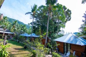 a cabin in a resort with palm trees at Ban_na in Ko Chang