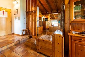 a room with a large wooden room with a bench in it at Casa dal Ri' in Fai della Paganella
