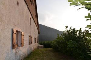 a building with windows on the side of it at gîte de la cheneau in Rochesson