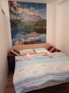 a bed in a room with a painting on the wall at Dado in Bijeljina