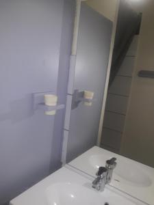 a bathroom with a sink and a mirror at Studio les deux alpes Résidence le Pluton B84 WIFI in Les Deux Alpes