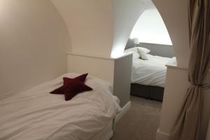 a bedroom with a bed with a red pillow on it at Bath Garden Apartment in Bath