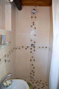 a bathroom with a shower with a sink and a tub at Suzie's Loft - NUDE - SunEden Family Naturist Resort in Pretoria