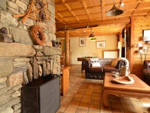 a living room with a large stone fireplace at Spacious chalet in Ovifat Waimes with sauna in Ovifat