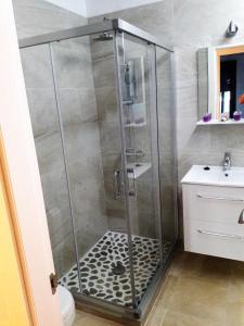 y baño con ducha y puerta de cristal. en Punta Paloma en Tarifa