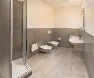a bathroom with two sinks and a toilet and a shower at Villa Pozzi in Sestri Levante