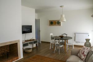 a living room with a couch and a dining room table at Encosta da Camarinha in Ferreira do Zêzere
