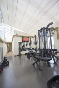 a gym with several treadmills and weights in a room at Hotel Talija in Banja Luka