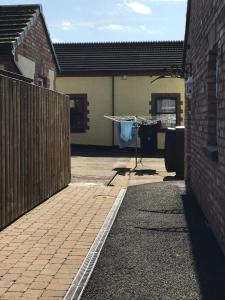 a backyard of a house with a clothesline and a fence at The Stables B&B in Antrim