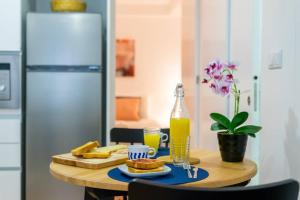 a table with a plate of food and a bottle of orange juice at Sé with Love- O seu novo local preferido in Braga