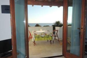 a room with a table and a view of a balcony at SENAFER Funtana Meiga in Funtana Meiga