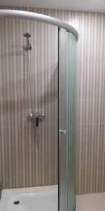 a shower with a glass door in a bathroom at Новая студия на пр. Соборном in Zaporozhye