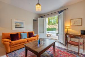 a living room with a couch and a table at Hotel La Fuente de la Higuera in Ronda