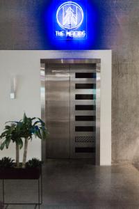 a metal elevator in a building with a blue sign at The Source Hotel in Denver