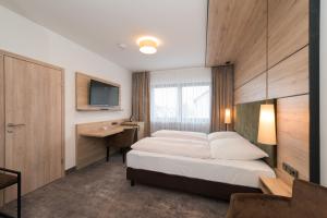 Postel nebo postele na pokoji v ubytování Hotel SCHNEIDER