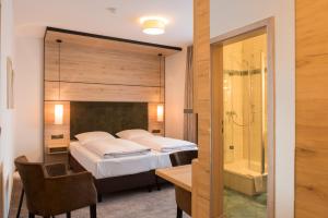 Postel nebo postele na pokoji v ubytování Hotel SCHNEIDER