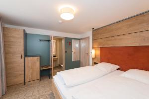 Postel nebo postele na pokoji v ubytování Hotel SCHNEIDER