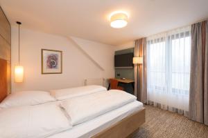 Postel nebo postele na pokoji v ubytování Hotel SCHNEIDER