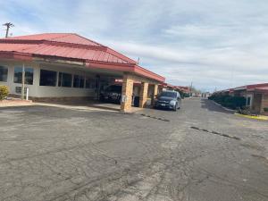 a car parked in front of a gas station at Executive Inn in Hobbs