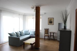 a living room with a couch and a table at Ferienwohnung am Fluss in Weischütz