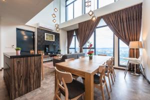 a dining room and living room with a table and chairs at WGS Suites at KLCC in Kuala Lumpur