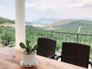 a potted plant sitting on a wooden table on a balcony at Manzara House in Kalkan