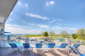 a balcony with chairs and a view of the ocean at Armada By The Sea in Wildwood Crest